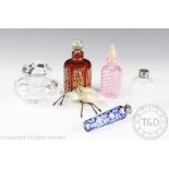 A selection of glass scent bottles and stoppers comprising; a Baccarat example, 9cm high,