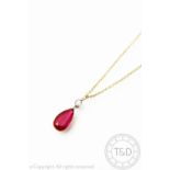 A red stone and diamond pendant, designed as a diamond suspending a pear shaped red stone set drop,