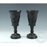 A pair of Victorian black pressed glass vases,