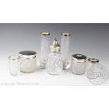 A selection of silver mounted glass wares and toilet jars to include a pair of George V silver