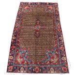 A Persian Hamadan Lori wool carpet, worked with a geometric panel and floral corners,