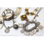 Two charm bracelets, each hung with numerous attached charms and fobs including silver examples,