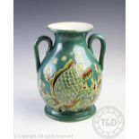 A sgraffito studio pottery amphora vase, decorated with a carp amongst a sea bed,