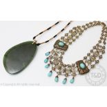 A Chinese necklace set with turquoise cabochons, of intricate design and clasp stamped 'SILVER',
