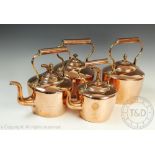 Four Victorian copper kettles and covers, largest 32cm high,