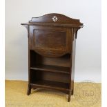 An Arts and crafts oak students desk, with fall front enclosing a fitted interior, over two shelves,