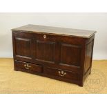 An 18th century oak mule chest, with hinged top above two drawers stile feet.