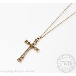A 9ct yellow gold cross pendant, of decorative openwork design with an attached chain stamped '9ct',