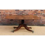 A 19th century mahogany rectangular breakfast table, with tilt top, on a carved and turned column,