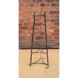 A wrought iron six tier saucepan stand