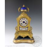 A French Louis XIV style gilt metal and porcelain mantel clock, 19th century,