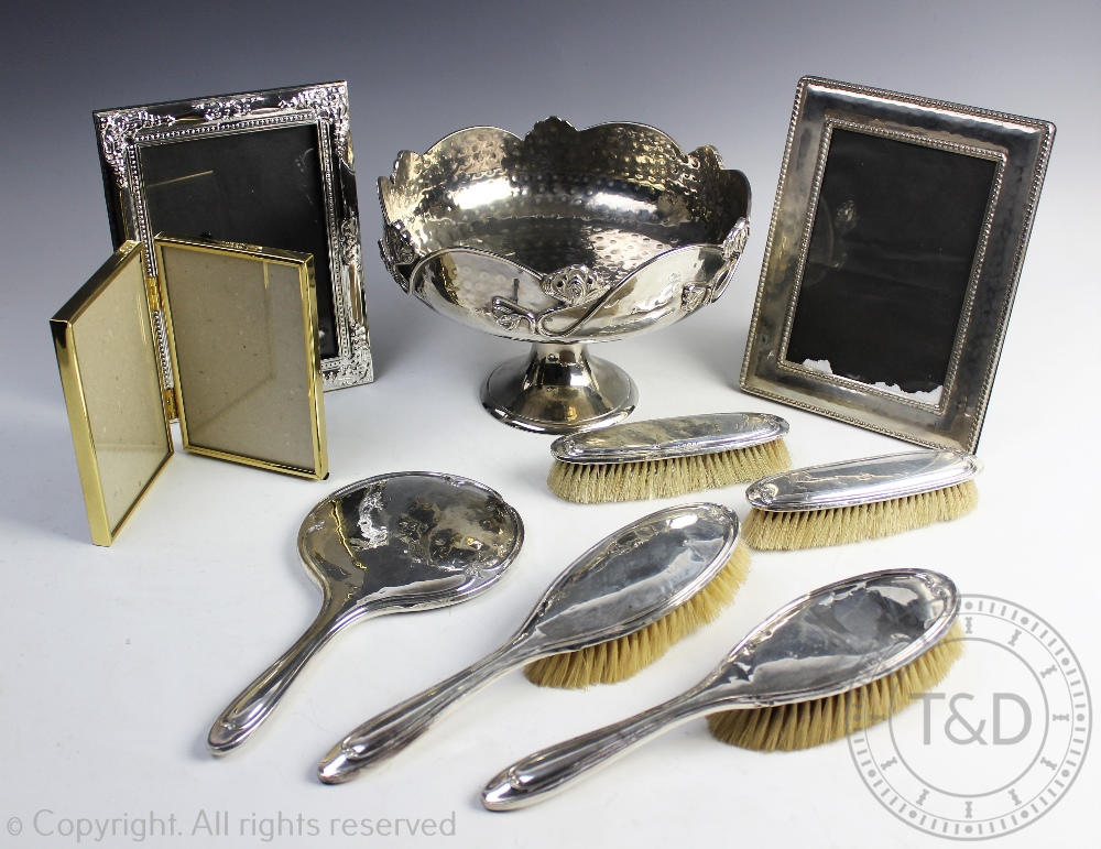 A George V set of five silver backed dressing table wares comprising; two hand brushes,