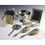 A George V set of five silver backed dressing table wares comprising; two hand brushes,