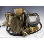 A WWII babies or young child's gas masks, a further WWII gas mask,