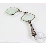 An Art Deco white metal lorgnette, set with paste gems, 10.