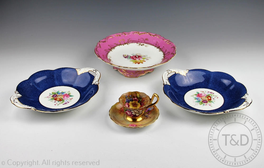 A Royal Worcester florally painted teacup and saucer, signed 'E.