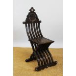 A Syrian carved hardwood campaign type folding chair,