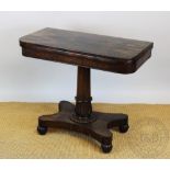 A William IV rosewood card table, with swivel top and carved column, on platform and gadrooned feet,