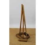 Five early 20th century croquet mallets and a painted steel wine rack (6)