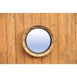 A Regency style gilt wood circular wall mirror with convex mirrored plate with surrounding ball