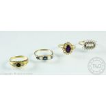 A collection of four assorted rings, to include; a sapphire and opal five stone ring in 9ct gold,