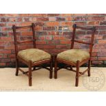 A set of six Arts and Crafts walnut dining chairs, of peg construction, with drop in seats,