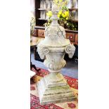A large pair of 19th century style reconstituted stone urns with rams head detail,