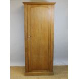 A pine single door wardrobe, with arched panel door,