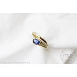 A sapphire set 'snake' ring, designed as a coiled serpent set with sapphire head,