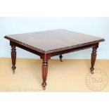 A Regency style mahogany extending dining table, the top with a moulded edge,