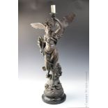 A bronze spelter figural lamp after Bruchon, modelled as Victory holding a torch,