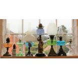 A collection of eight oil lamps to include a chamber oil lamp and flute, 33.