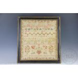 A Victorian needlework sampler by Ann Kinsey aged 9 and dated 1849, worked with alphabets,