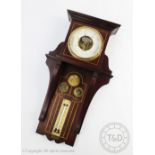 An early 20th century Secessionist type inlaid mahogany aneroid barometer,