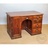 A late Victorian pitch pine desk, with an arrangement of six drawers,