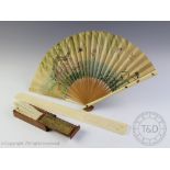 A Japanese carved ivory page turner Meiji period (1868-1912), decorated with two panels of Geisha,