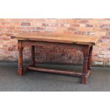 A 17th century style carved oak extending refectory type table, with two leaves, on turned legs,