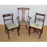 Two Regency mahogany dining chairs, including one on sabre legs,