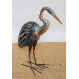 A modern painted metal model of a heron,