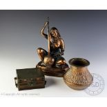 A Eastern copper model of a seated female playing a string instrument, 28cm high,