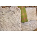 A pair of crochet bedspreads, each with stylised floral design and fringe,