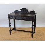 A late Victorian carved oak hall table,