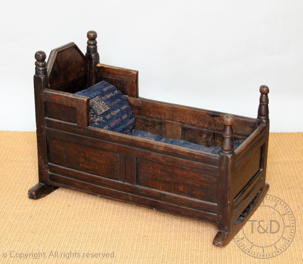 An 18th century oak cradle,