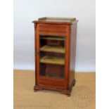 A late Victorian walnut music/display cabinet on bracket feet,