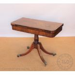 A Regency mahogany and rosewood card table, with turned column and reeded legs,