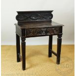 A Victorian carved and stained oak side table,