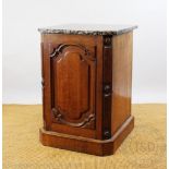A Victorian oak cupboard, with marble top and moulded door, on plinth base,