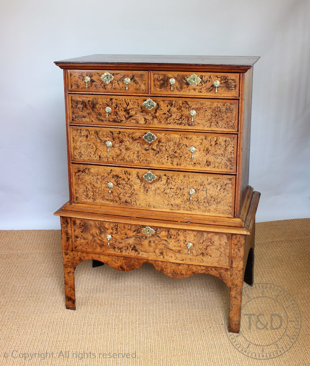 An 18th century style walnut and burr walnut chest on stand, incorporating some earlier timbers,