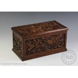 An Art & Crafts carved oak rectangular casket,