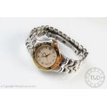 A ladies Ebel Sportwave stainless steel bi-colour wristwatch, Roman numeral dial with date aperture,